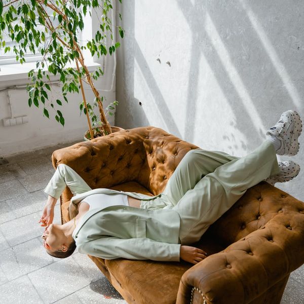Person meditating peacefully in a bright, sunlit room.